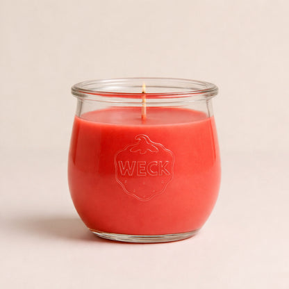 Duftkerze in hellem Rot im WECK-Glas vor neutralem Hintergrund, zentriert und weich ausgeleuchtet – klare Studioaufnahme.