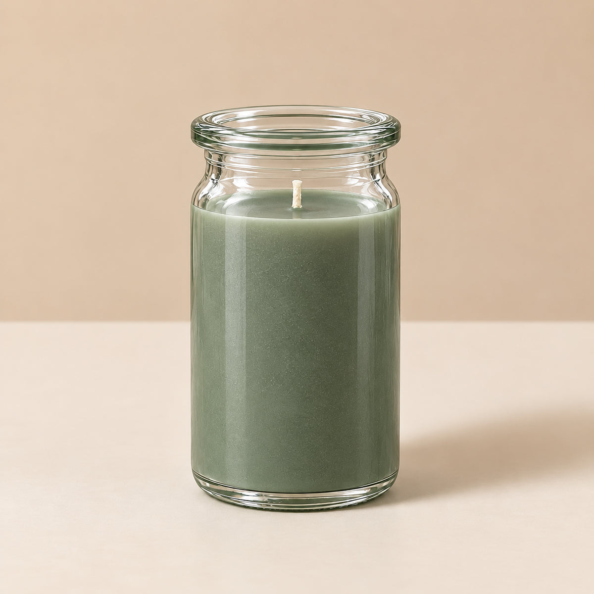 grün-graue kleine Duftkerze aus Kokoswachs im originalen WECK-Glas von CandleDeko, vor neutralem Hintergrund.