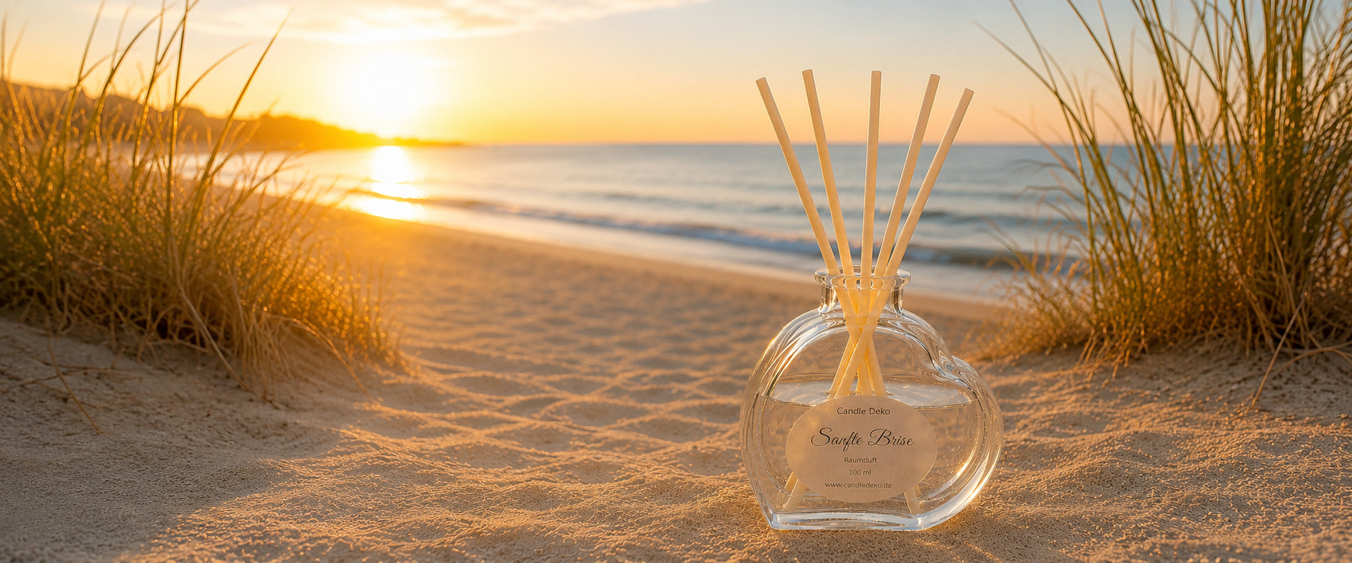 Sanfte Brise Raumduft im Herzglas mit Duftstäbchen am Sandstrand bei Sonnenuntergang.