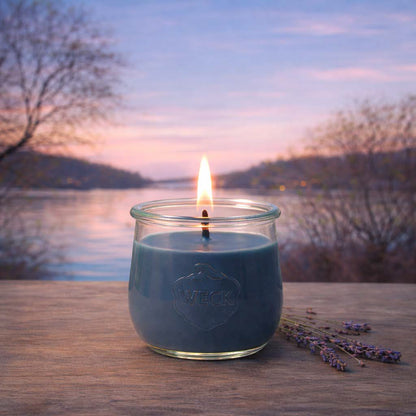 Brennende blaue CandleDeko Windstille grosse Duftkerze im WECK-Tulpenglas am See im kühlen herbstlichen Abendlicht.